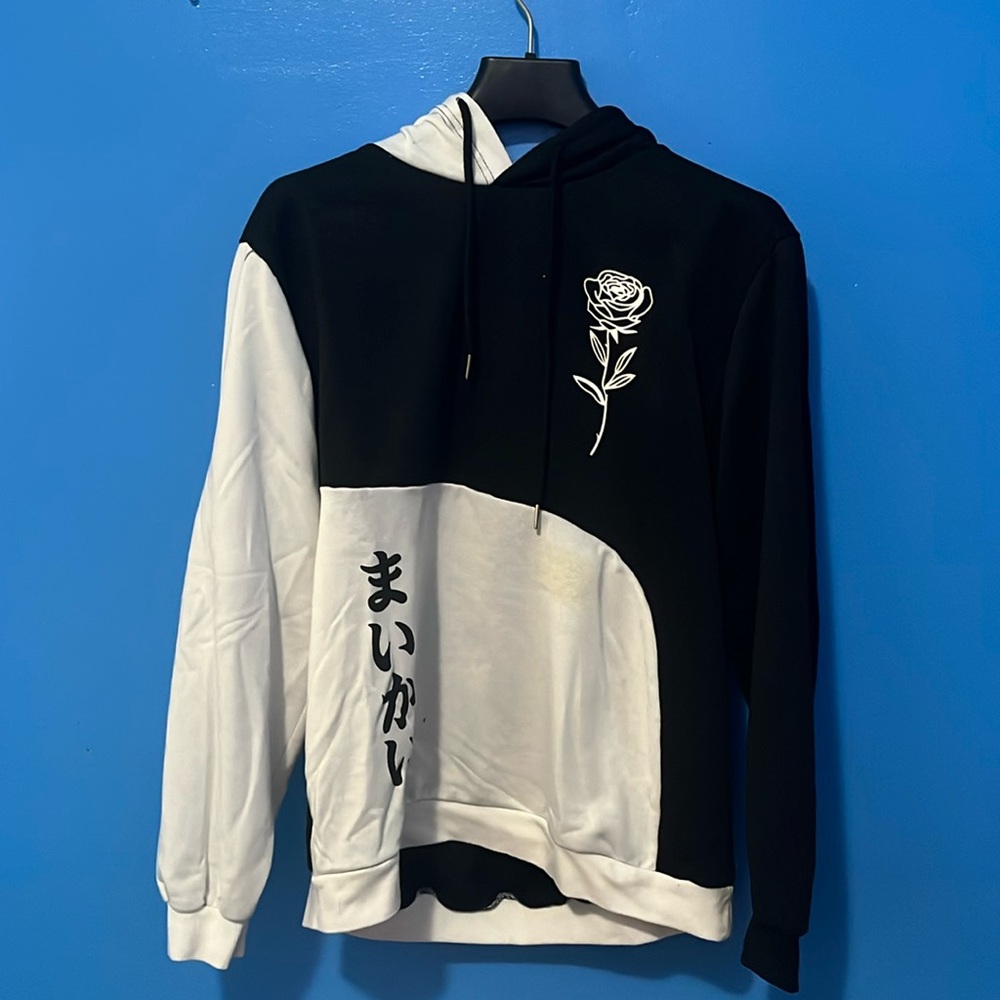 Black and white rose sweater with which seems like Chinese characters.